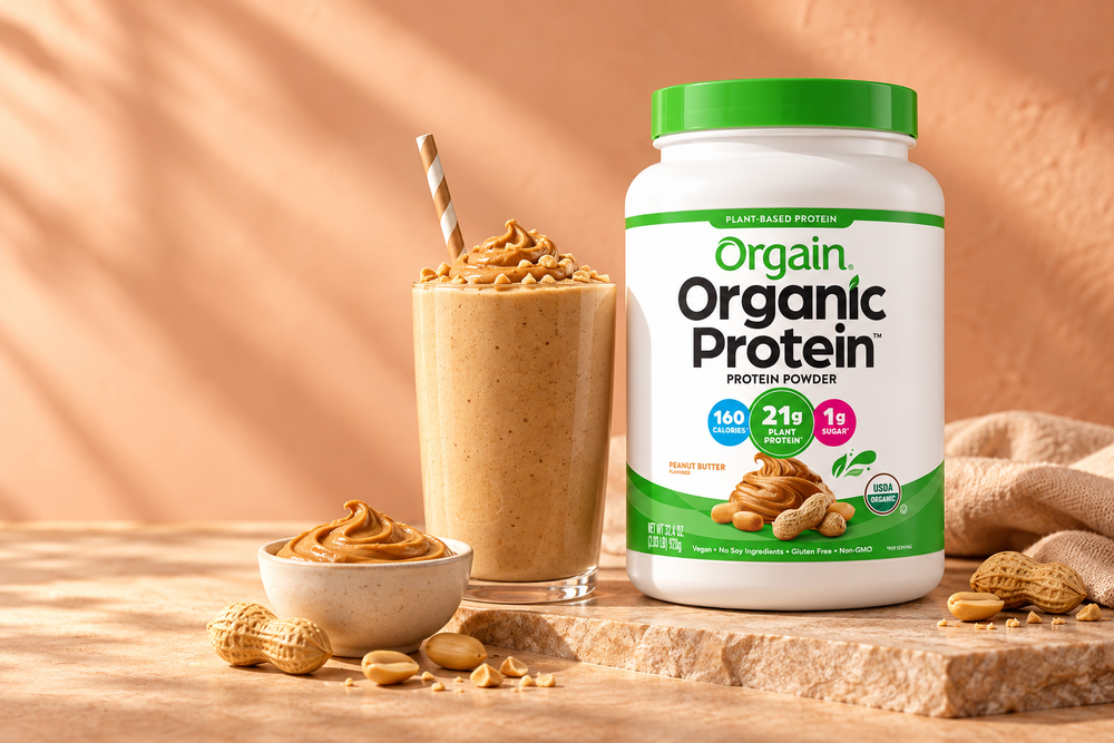 Orgain Peanut Butter with a peanut butter smoothie on a peach backdrop