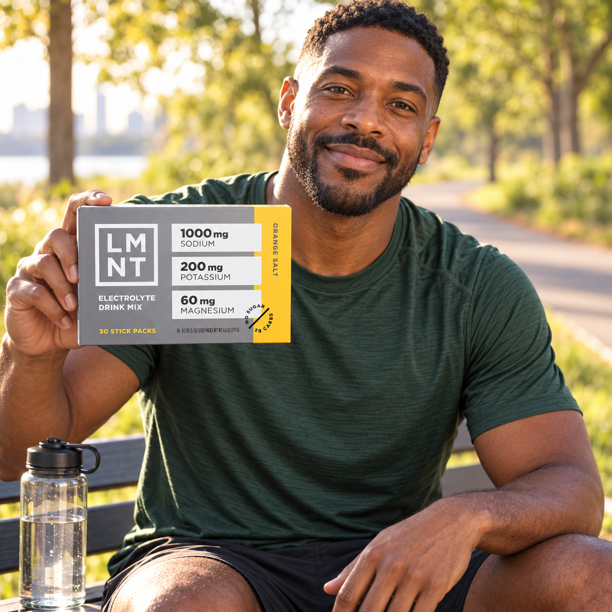 Lifestyle illustration: man holding the LMNT Orange Salt 30-stick box outdoors